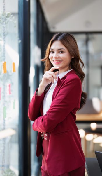 Beautiful young teen asian businesswoman using note pad thinking  with planning working on financial document, tax, exchange, accounting and Financial advisor.