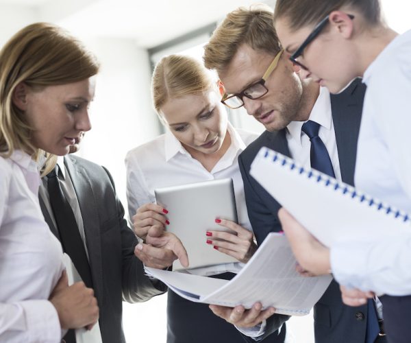 Business people reading in booklet